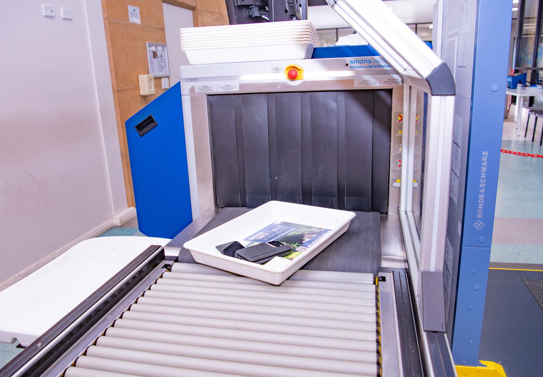 Passenger belongings passing through an airport security screening scanner.